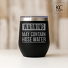 12oz laser engraved stainless steel wine tumbler with ‘Warning: May Contain Hose Water’ design.